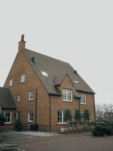 Traditional brick house with sloped roof in Hoofddorp, Netherlands, showcasing Dutch architecture.